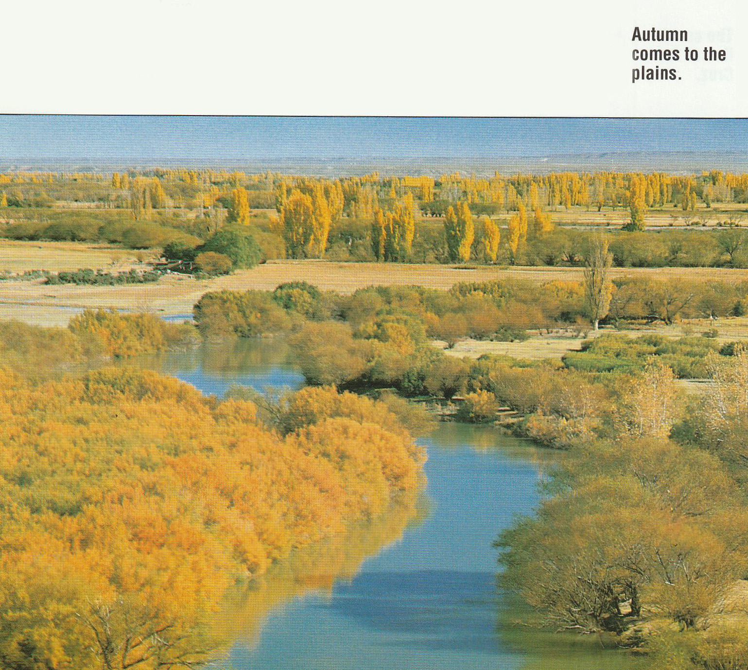 A winding river weaves through golden plains. Caption reads 'Autumn comes to the plains'.